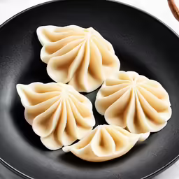 three dumplings in a pan on the counter