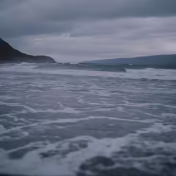 a wave crashing on the beach as seen from the shore