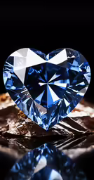 a heart shaped blue diamond is shown on a table