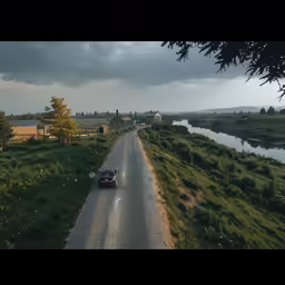 the car is traveling down the street by the water