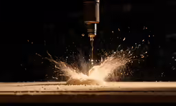 a piece of wood with a machine cutting on it
