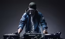 a dj mixing music while wearing a hoodie