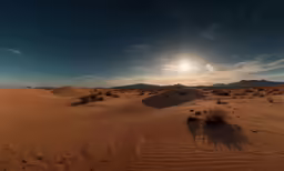 an arid desert has a blue sky and clouds