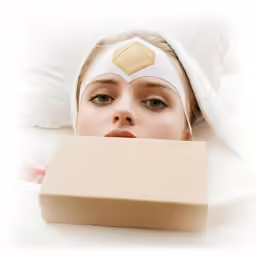 a girl with a bandaged head and a pillow