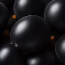 close up of black eggs with a dark background