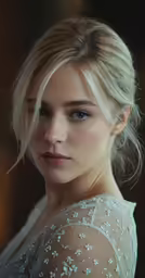 the beautiful blonde woman is posing for a photo