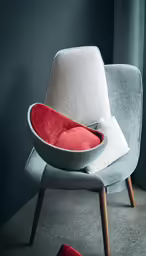 an upholstered chair with red cushions