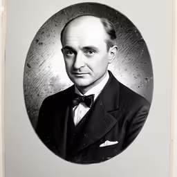 a portrait of a man with a suit and bow tie