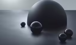 a couple of black balls that are on top of a table