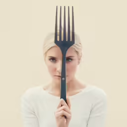 the woman has a long fork in her hands