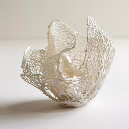 a close up of a white paper object on a table