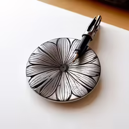 a pen is resting on a metal object