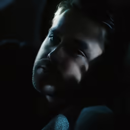 the man is sitting in the car alone