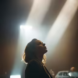 a person standing in front of some spotlights on a stage