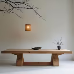 a light is attached to the wall near a table with a bowl