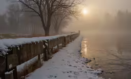 a misty park with a frozen lake and bridge