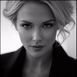 an elegantly dressed woman looks straight ahead
