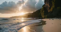 the sun is setting over an ocean on a beach