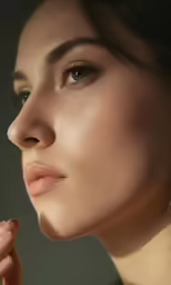 a woman with her hand resting in her mouth