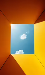 view through a blue and yellow wall into a white cloud