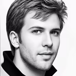 a man posing for the camera in black and white