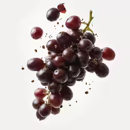 a group of grapes falling into the air
