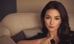 a very attractive woman holding a remote in her hand