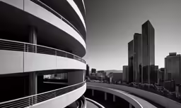 a black and white photo of buildings and a freeway