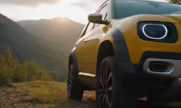 there is a yellow car parked near the mountains
