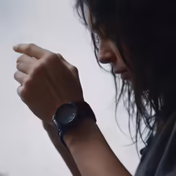 a woman is holding her hand together with one hand