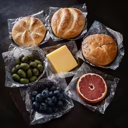 some breads and some fruit on top of a table