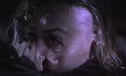a woman with freckled hair covers her face