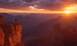 two people at the edge of a mountain looking down