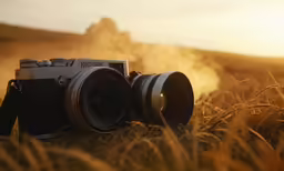 a camera sitting in the middle of a wheat field