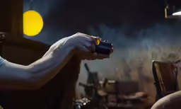 a person is holding a flashlight in their hand