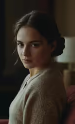 an elegant woman with braids and a turtle neck sweater looks to the left