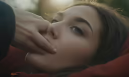 a close - up image of a woman holding the face of another women