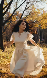 a woman in white dress is in the park