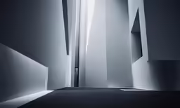 the interior is dark and empty and the light comes in through a window