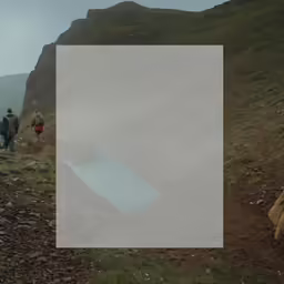 a large white sheet sitting on the side of a mountain