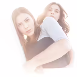 the girl is leaning against the wall and the man is posing