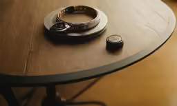 two phones are resting on top of a table