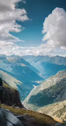 mountains can be seen in the background as a man sits atop a hill