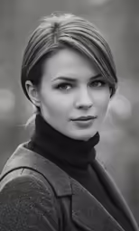 a woman poses for the camera in black and white