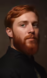 a close up of a man with a beard wearing a black shirt