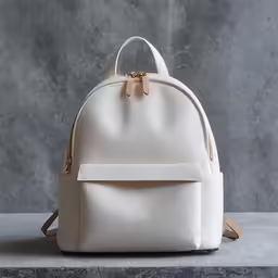 a white backpack with the strap hanging down on it