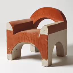 an odd shaped chair sits against a white background