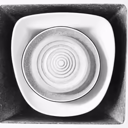 a white bowl with an abstract design in the center