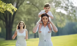 woman carries a boy in her arms while another runs by