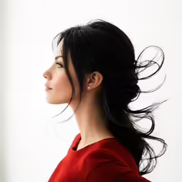 a woman in a red shirt is looking away
